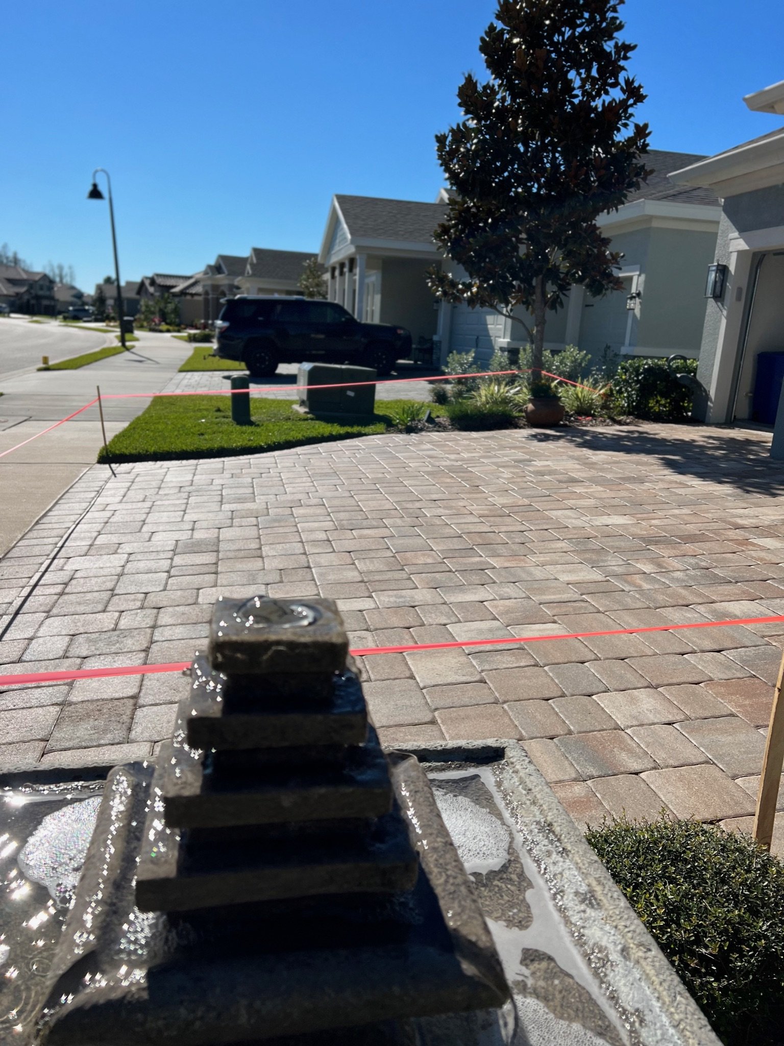 Albert Kelly applying fresh sealer on Belgard pavers